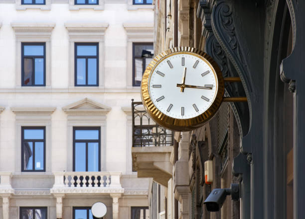 istock Golden colored clock in an urban context 1164600914