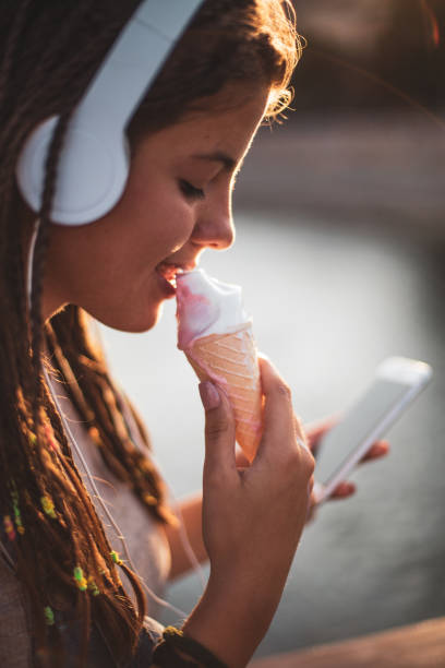 istock Young man listens to music and eats ice cream 1164602447