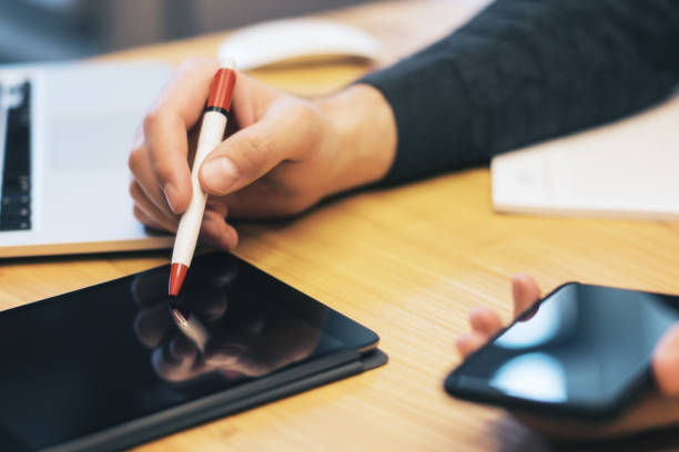 istock Sideview of businessman hand using gadgets 1164602658