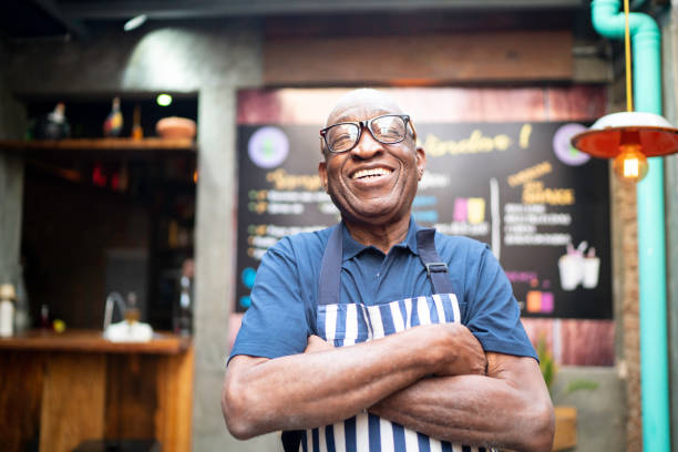istock Portrait of smiling elderly waiter looking at camera 1164605871
