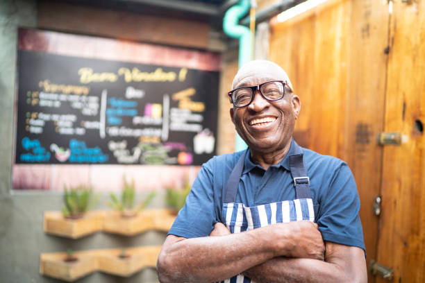 istock Portrait of smiling elderly waiter looking at camera 1164605922