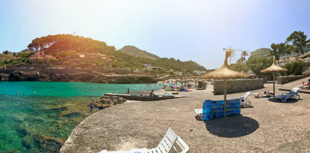 Beach umbrella and empty chairs with sea view in Port de Pollenca in Mallorca, Spain.