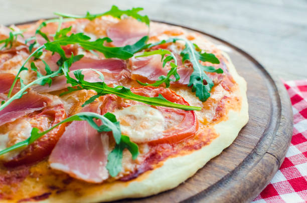 istock Italian pizza with prosciutto and arugula 1164612110