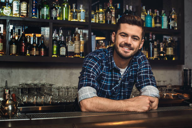istock Young bartender leaning at bar counter smiling cheerful 1164612721
