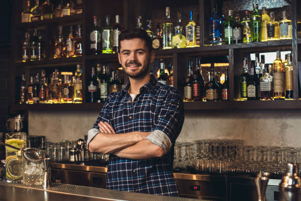 istock Young bartender standing at bar counter crossed arms looking camera cheerful 1164612726