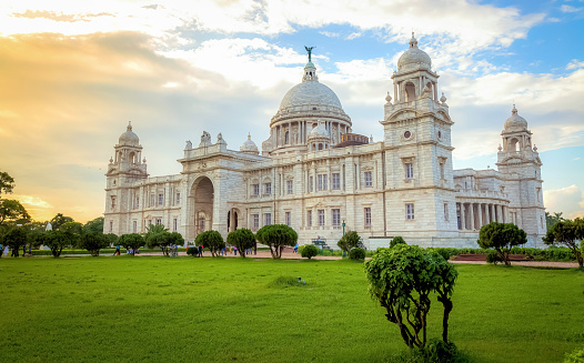 Victoria Memorial is a large marble building in Kolkata, India, built between 1906 and 1921 in the memory of Queen Victoria. Historic Victoria Memorial colonial architecture monument at sunset
