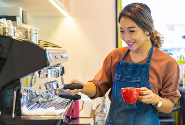 istock Female Asian barista making cappuccino 1164621906