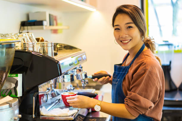 istock Female Asian barista making cappuccino 1164621907