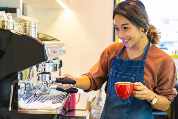 istock Female Asian barista making cappuccino 1164621908