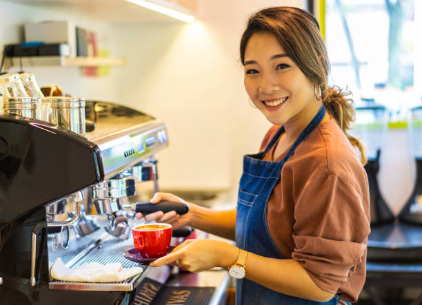 istock Female Asian barista making cappuccino 1164621910