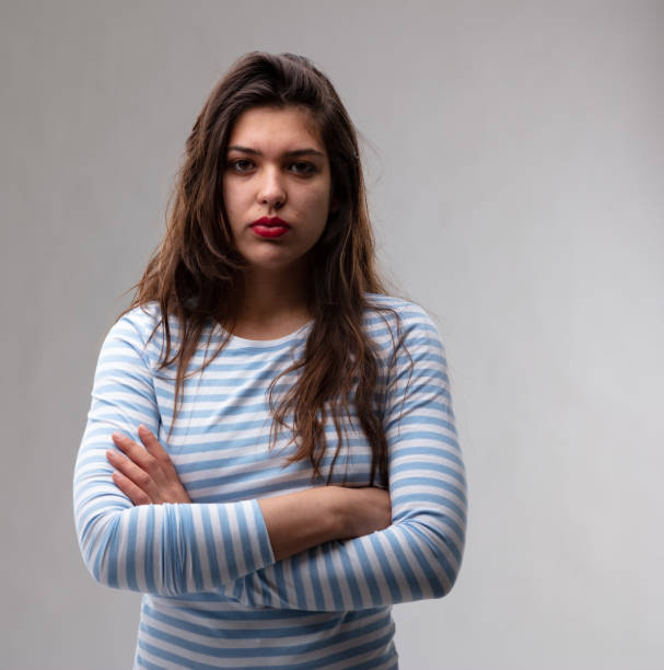 istock Young woman with a deadpan stern expression 1164623542