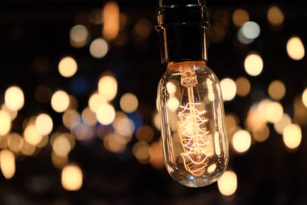 istock close up shining golden electric bulb details 1164623698