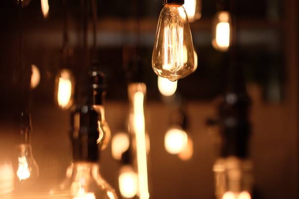 istock close up to golden shining bulbs in dark environment. 1164625324