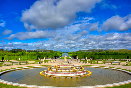Versailles, France - April 24, 2019: Fountain of Latona in the garden of Versailles Palace on a sunny day outside of Paris, France.