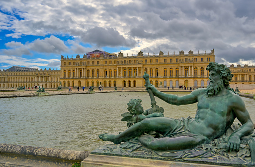 Versailles, France - April 24, 2019: The statues and fountains in and around the garden of Versailles Palace on a sunny day outside of Paris, France.