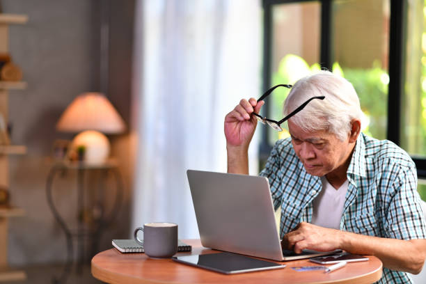 istock Asian senior man looking confuse when using credit card for online shopping 1164628953
