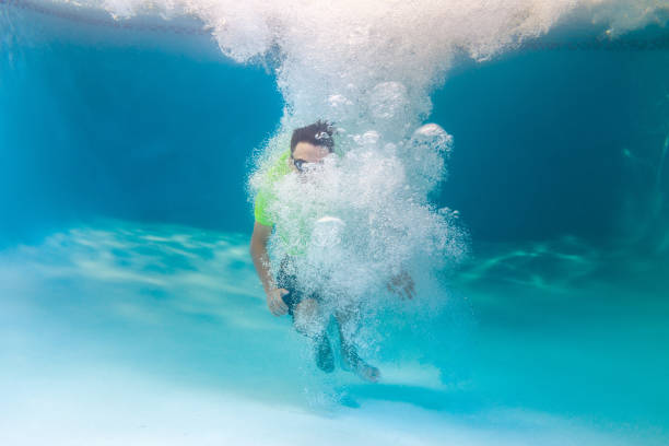 istock Teen jumping on a pool 1164638671