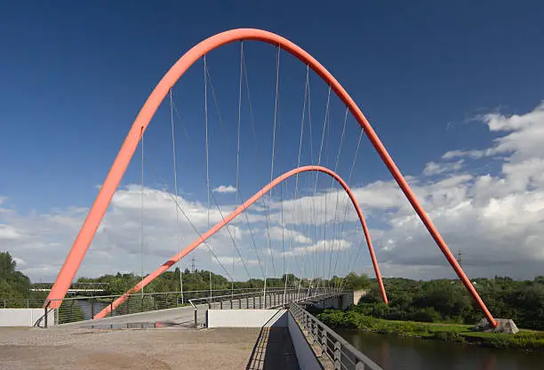 A modern suspension bridge for pedestrians over a canal in Gelsenkirchen, Germany.