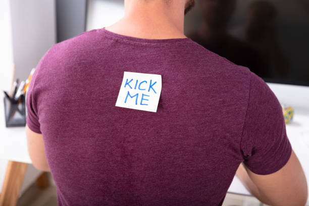sticky-note-with-kick-me-text-on-mans-back.jpg