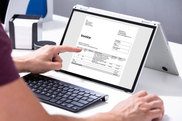 istock Businessman's Hands Working On Invoice On Laptop 1164644012