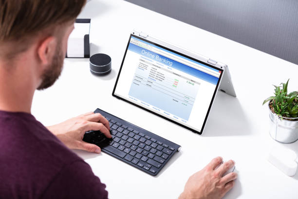 istock Businessman's Hand Pointing The Online Banking Form On Laptop 1164644017