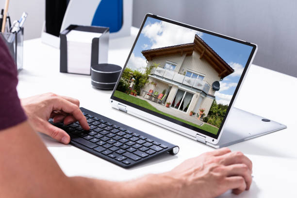 istock Man selecting new house on laptop at home 1164644023