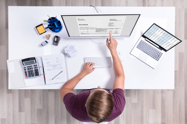 istock Businessman Checking Invoice On Laptop 1164644121