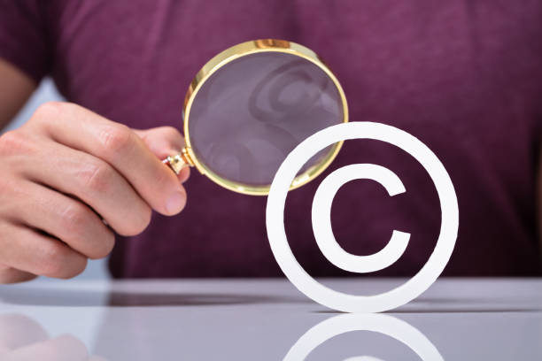 istock Magnifying Glass With White Copyright Symbol Icon 1164644192