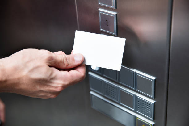 istock Person Holding Key Card Near Elevator Button 1164644219