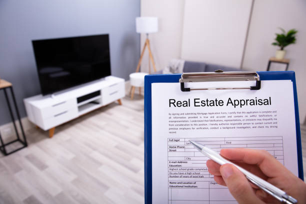istock Person Hand Filling Real Estate Appraisal Document 1164644360