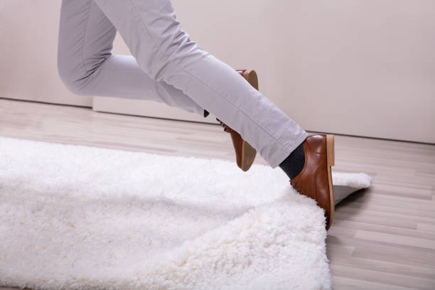 istock Man Stumble In A Carpet Near Ladder 1164644361