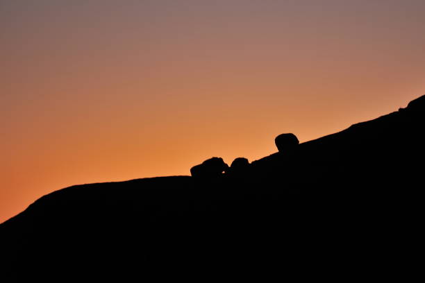 istock Silhouette of mountains and stones at sunset. 1164644691