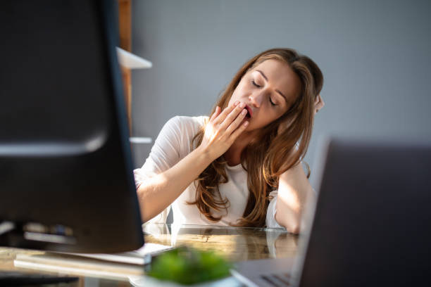 istock Businesswoman Yawning In Office 1164644779