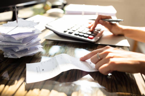 istock Businesswoman Checking Bill Over Desk 1164644788