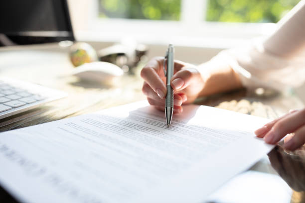 istock Businesswoman's Hand Signing Contract With Pen 1164644796
