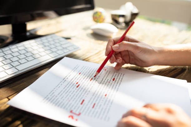 Person Marking Error With Red Marker Close-up Of A Person's Hand Marking Error With Red Marker On Document article photos stock pictures, royalty-free photos & images