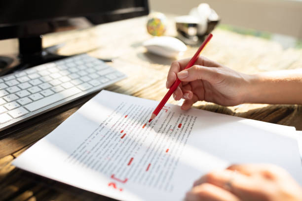 Person Marking Error With Red Marker Close-up Of A Person's Hand Marking Error With Red Marker On Document textual symbol stock pictures, royalty-free photos & images