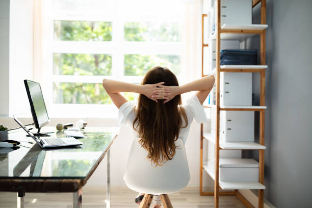 istock Relaxed Businesswoman Sitting In Office 1164644842