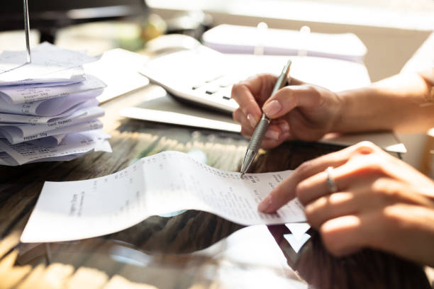 istock Businesswoman Checking Bill Over Desk 1164644848