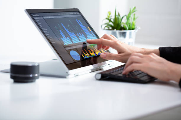 istock Businesswoman Analyzing Graph On Laptop At Workplace 1164645434