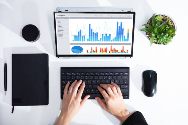 istock Businesswoman Analyzing Graph On Laptop At Workplace 1164645442