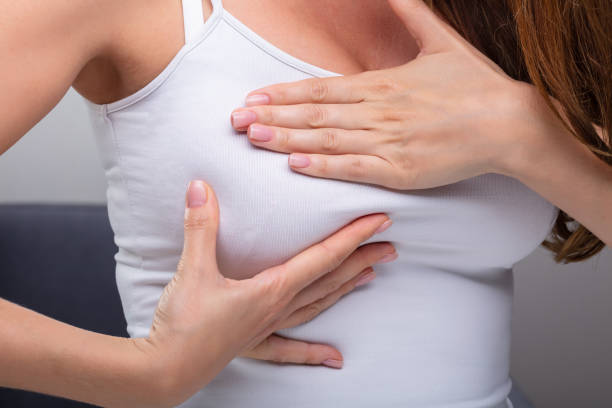 istock Woman Pressing Her Breast 1164645587