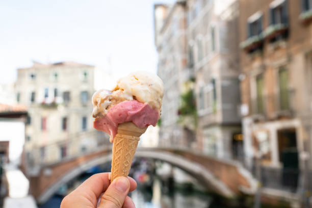 istock Person's Hand Holding Ice-cream Cone At Venice 1164645774