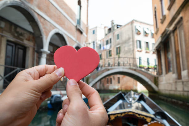 istock Couple Holding Heart Shape While Riding Gondola 1164645831