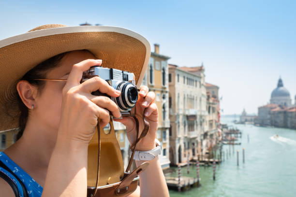 istock Woman Taking Pictures On Camera In Venice 1164646425