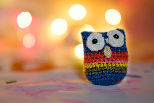 istock handmade from wool bound owl on festive background bokeh against lamps 1164647427