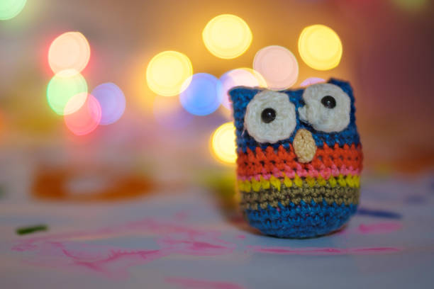 istock handmade from wool bound owl on festive background bokeh against lamps 1164647431