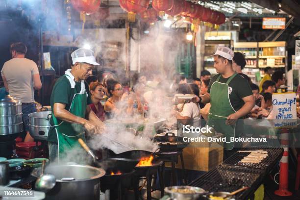 Chef Cooks In A Wok Outdoors In Yaowarat Road Bangkok Thailand Stock Photo - Download Image Now