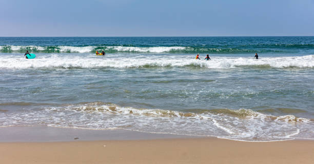 istock Surfers going to surf, ocean sea waves in a sunny spring day 1164647667