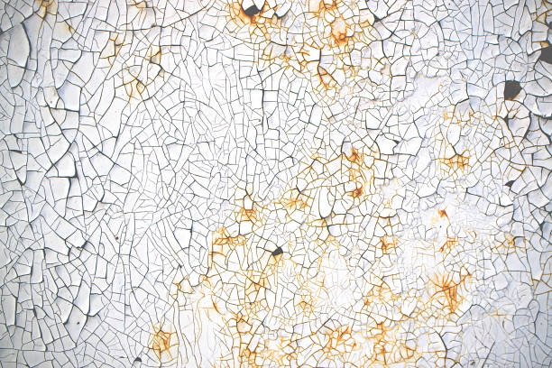 istock peeling paint in small pieces with a rusty old metal surface 1164648356